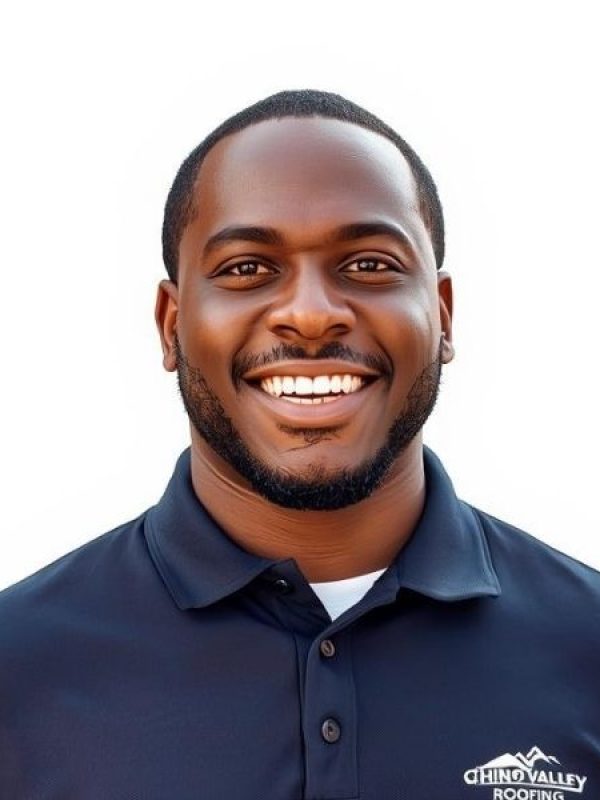 Professional project manager for Chino Valley Roofing in a navy blue branded shirt, smiling confidently.